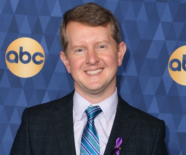 ken jennings stands on red carpet