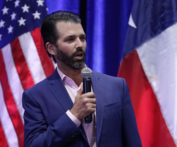 donald trump junior speaks into a mic at a campaign rally