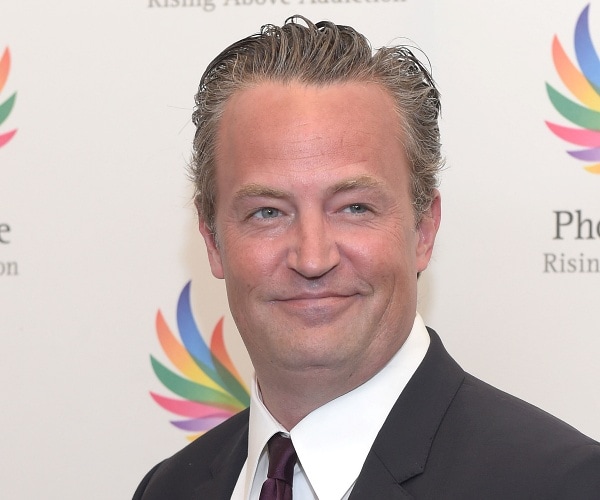 matthew perry stands on red carpet