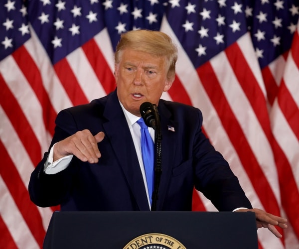 donald trump stands behind podium