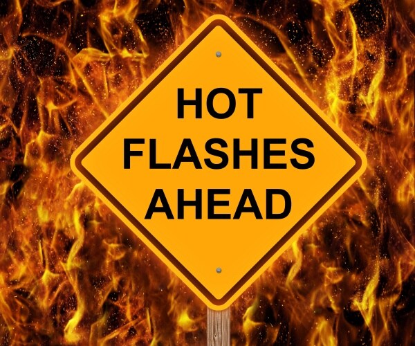 road sign in flames says "hot flashes ahead"