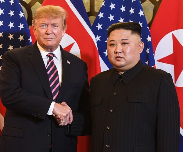 president trump and president kim pose for pictures