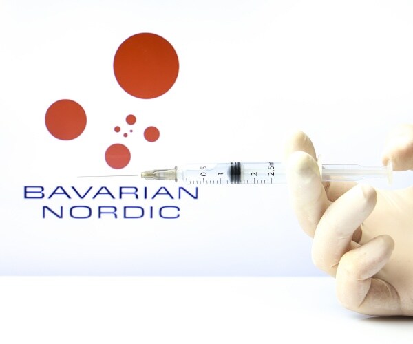 Bavarian Nordic and syringe being held by a hand with surgical glove, pointed at monkeypox virus