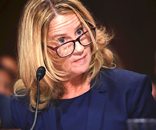 Christine Blasey Ford tilts her head to the side in surprise during her senate judiciary testimony