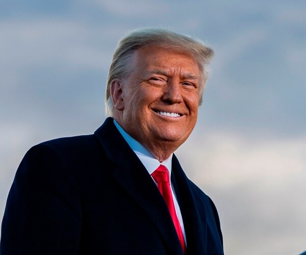 donald trump stands on tarmac