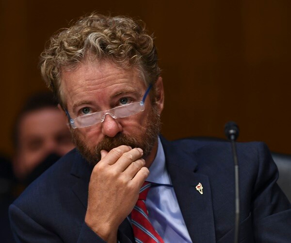 rand paul glances over his reading glasses