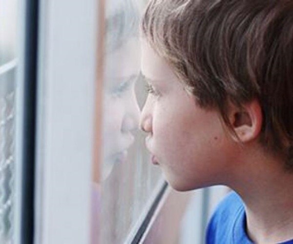 boy looking out window