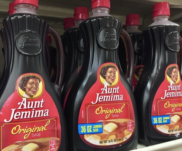 rows of bottles of aunt jemima maple syrup