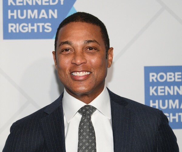 don lemon stands on red carpet