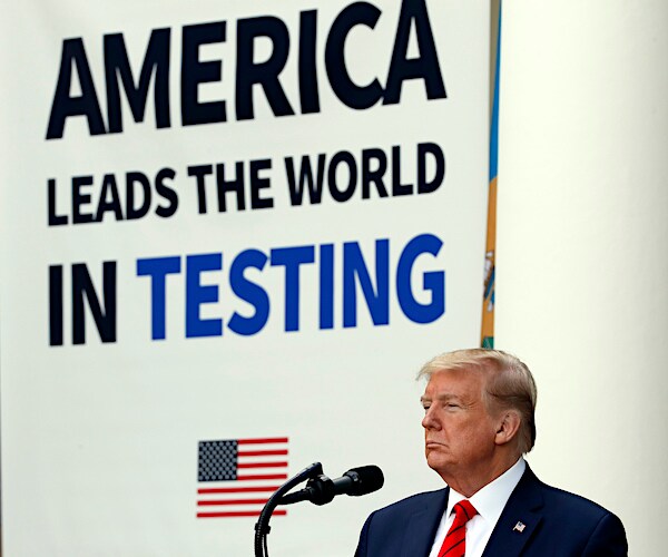 president donald trump delivers a news conference in front of a sign that reads the united states leads in testing