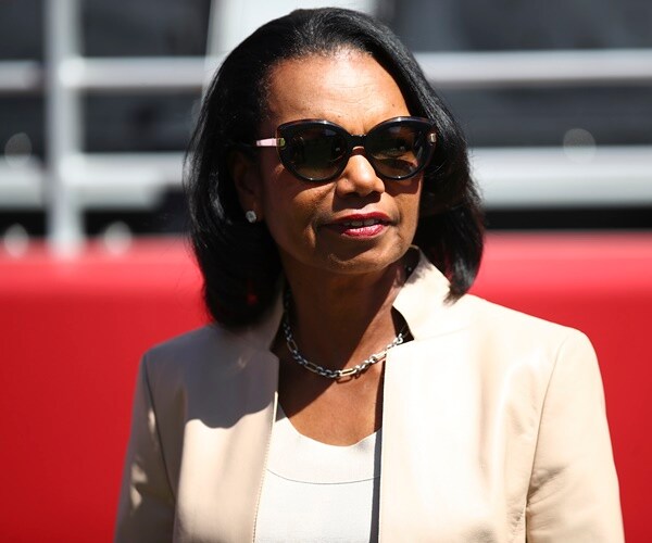 condoleezezza rice stands on the sidelines of an nfl football game