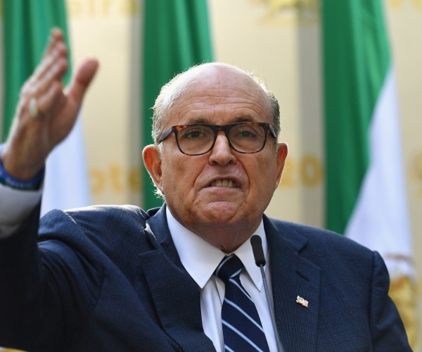 giuliani in a suit and navy blue striped tie