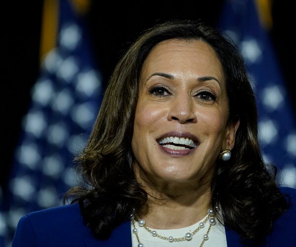 kamala harris speaks at a podium