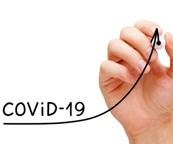 hand drawing on white board an arrow up, labeled COVID-19 cases