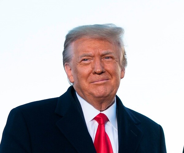 donald trump smiles on tarmac