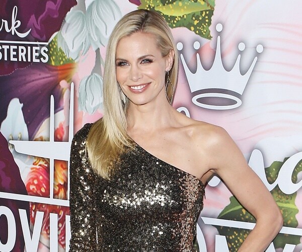 brooke burns stands on red carpet