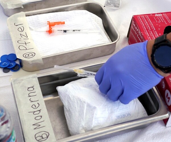 Syringes with vaccines are prepared at health center in Los Angeles