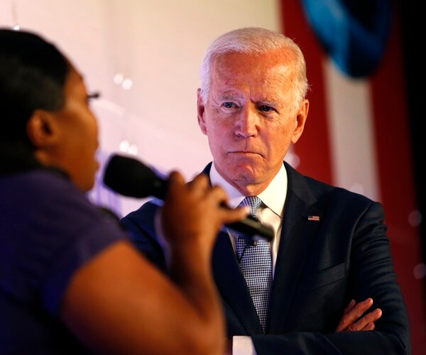 joe biden listens to a question from the audience at a union forum