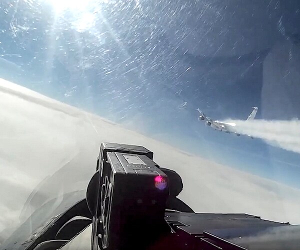 a cockpit view of a russian fighter jet intercepting an american plane