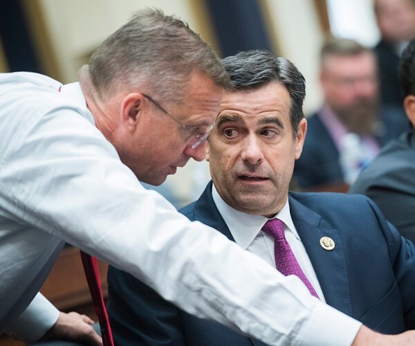 doug collins leans in to speak with john ratcliffe