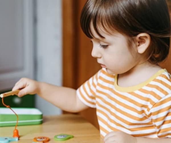 preschool-aged child playing with a toy