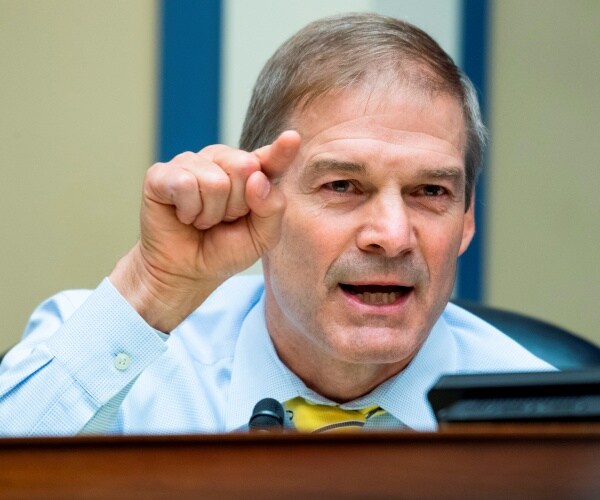 jim jordan, seated at a mic,  speaks and points