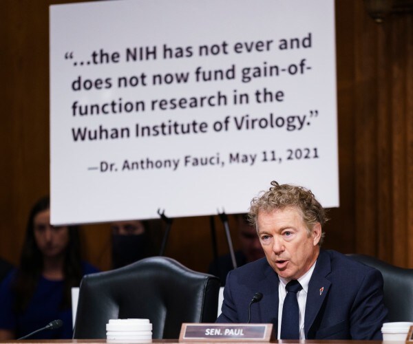 kentucky senator rand paul with poster of statement by dr anthony fauci 