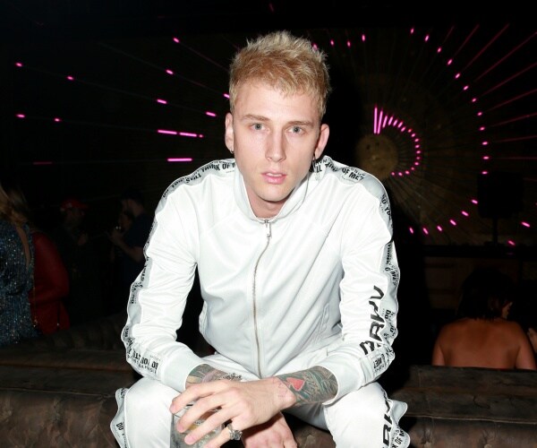 machine gun kelly in a white tracksuit