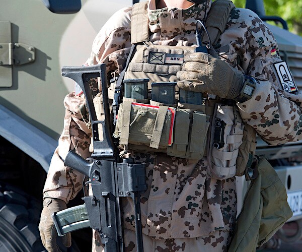 an afghanistan soldier with his full desert tactical gear on