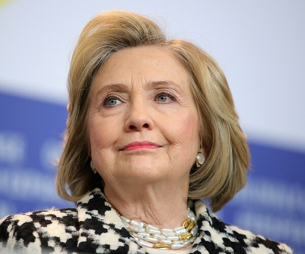 hillary clinton smiles at press conference