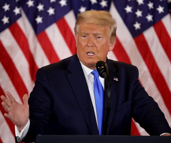 donald trump stands behind podium