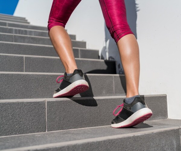 woman's feet sprinting upstairs during workout