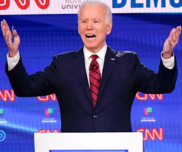 joe biden throws both hands up in the air during a debate