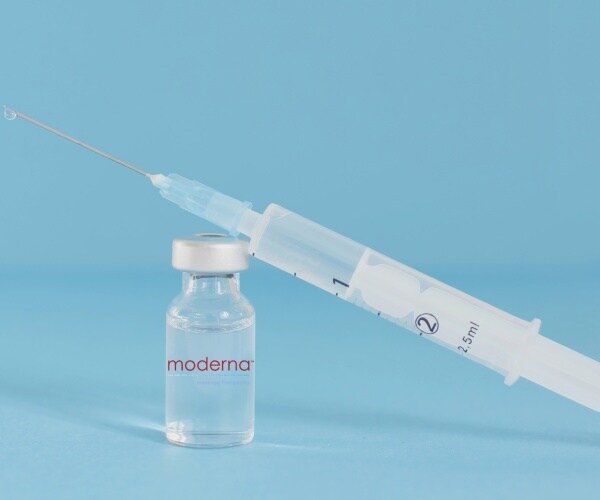 vial labeled Moderna and a syringe