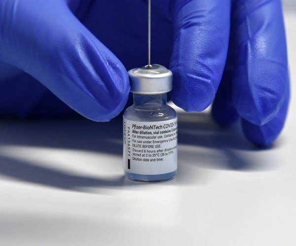 pfizer vaccine is shown with a syringe