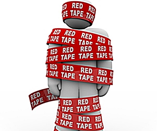 white figure wrapped in red tape from head to toe with red tape spelled out in white block letters