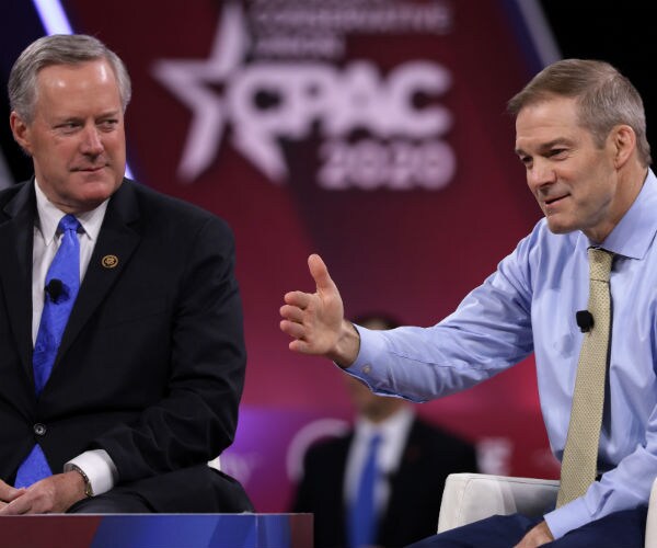 mark meadows, left and jim jordan are shown with the cpac logo in the background