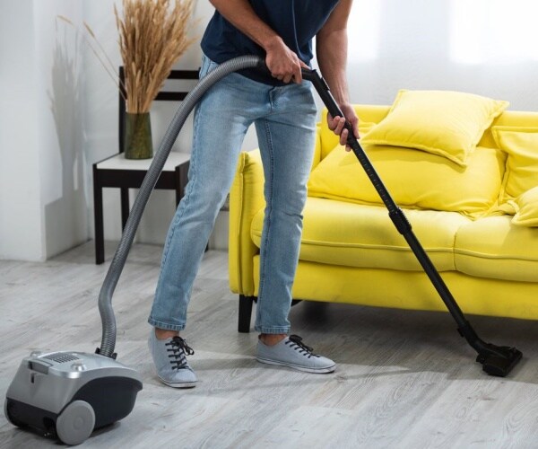 man vacuuming living room 