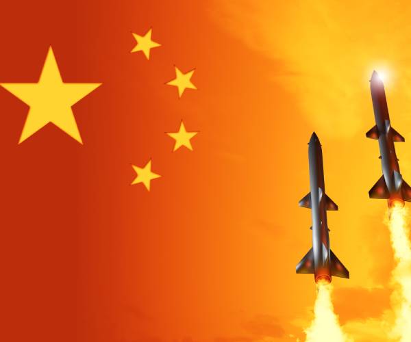 chinese flag with missiles in front