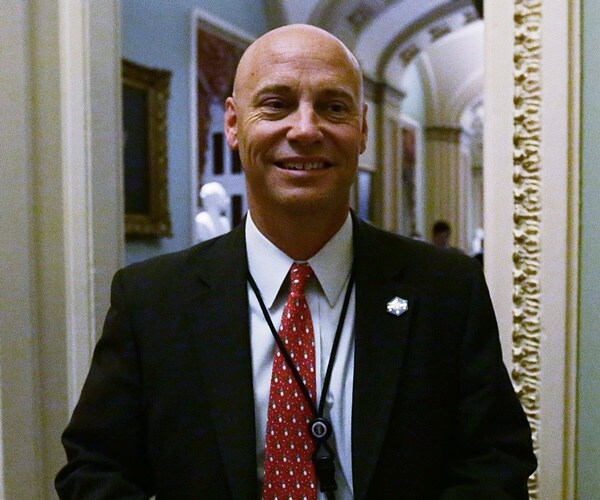 marc short walks thorugh the halls of the white house