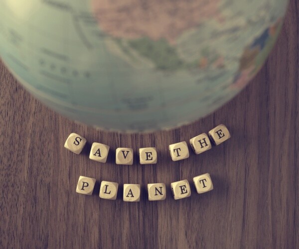 h a globe on a wooden table and the word save the planet