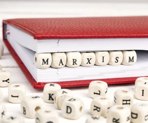 the word marxism spelled with beads and placed inside a book