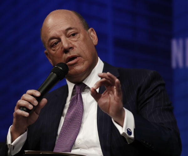 former white house press secretary ari fleischer speaking in washington in black suit, white dress shirt and purple tie