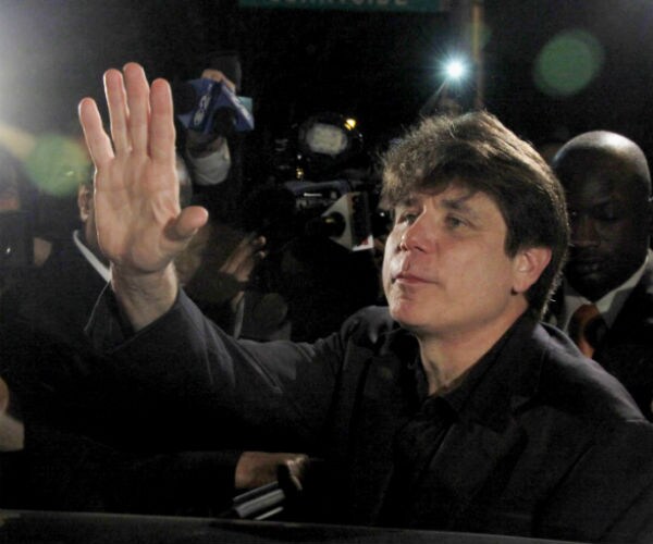 former illinois gov. rod blagojevich, wearing all black, waves as he departs his chicago home for prison