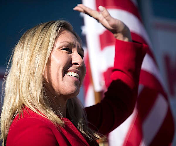 marjorie taylor greene waves during his introductory congressional photo shoot