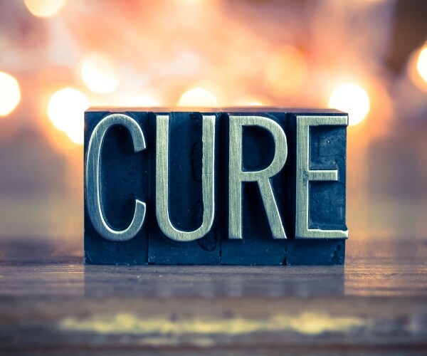 a wood cut-out that says "CURE"