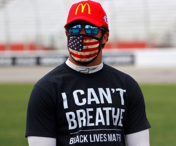 wallace in a mcdonald's hat and black lives matter tshirt with an american flag face mask