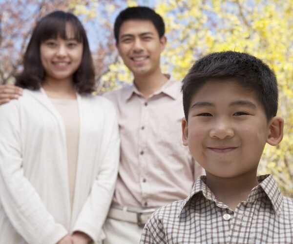 portrait of happy smiling chinese family in the park