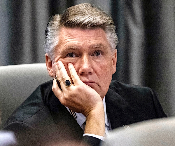 north carolina republican rests his face in his right hand while listening to court testimony