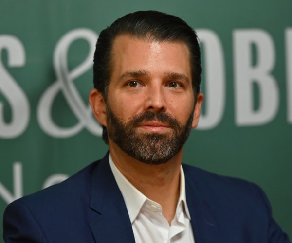 don jr in a navy blue suit and white shirt 